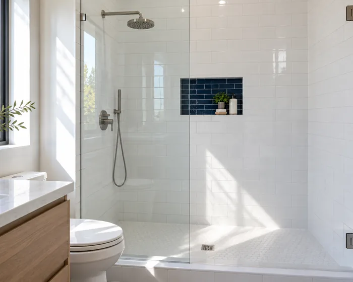 White subway tile walk-in shower, black-frame glass door, tile bench